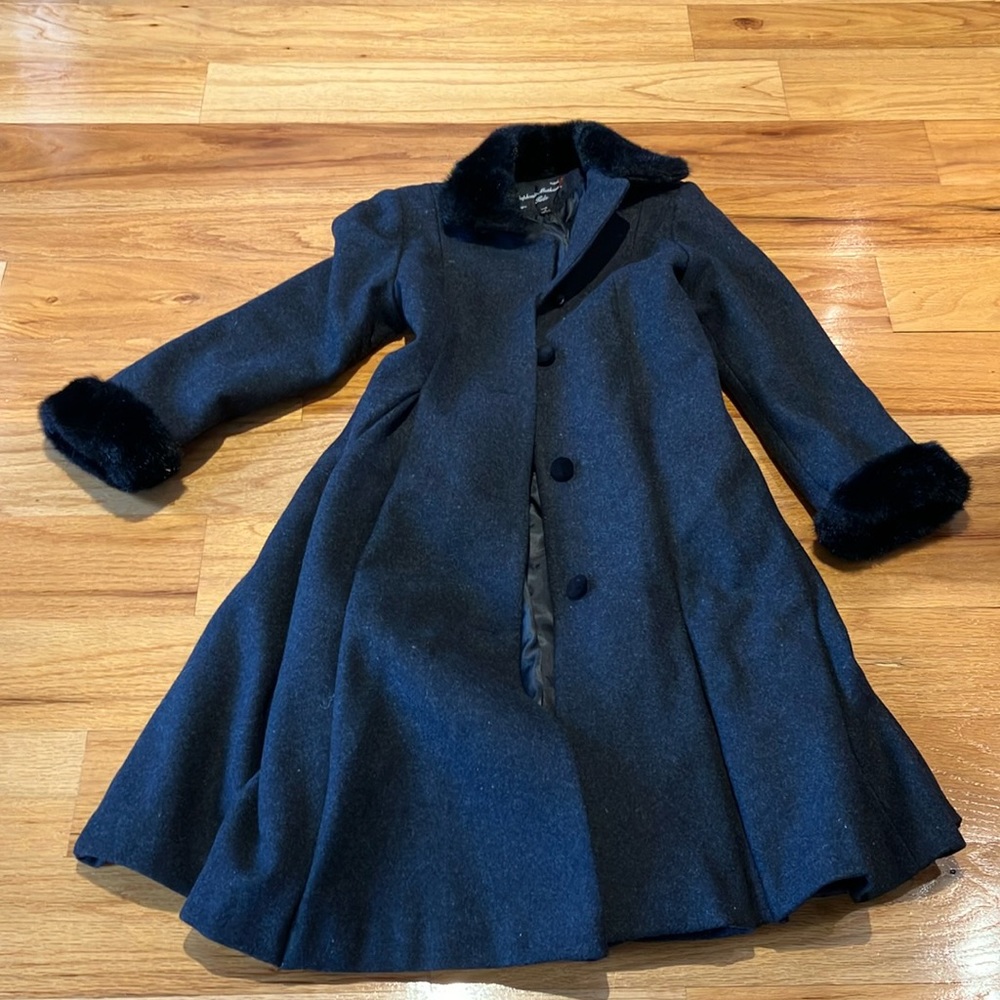 Girls long button up coat with pockets. Faux fur trimmed collar and cuffs.